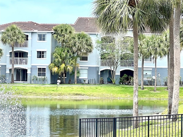 property view of water featuring fence