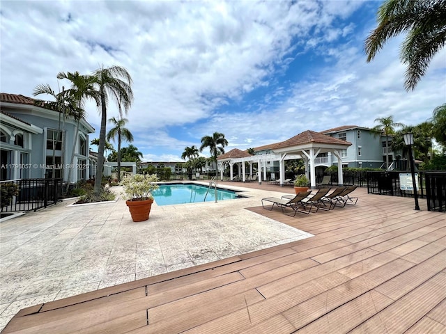 pool with fence, a patio, and a gazebo