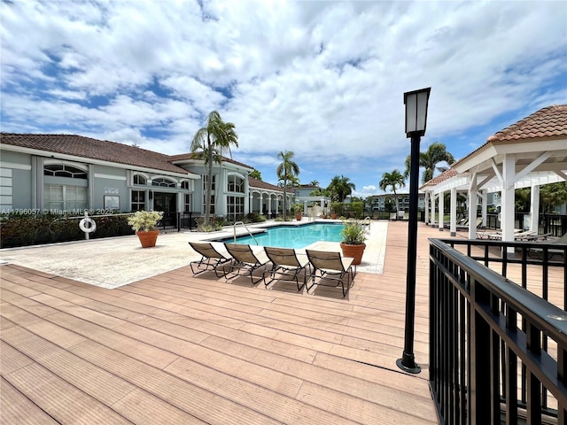 wooden deck with a community pool