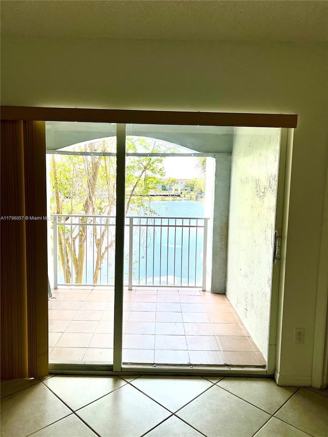 doorway to outside with tile patterned floors