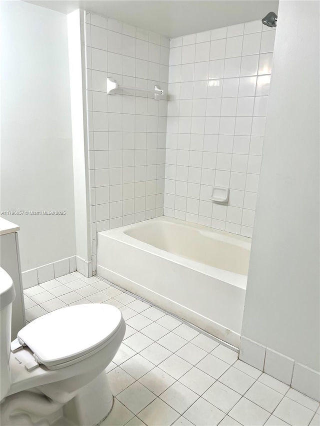full bathroom with shower / bathtub combination, toilet, tile patterned floors, and baseboards