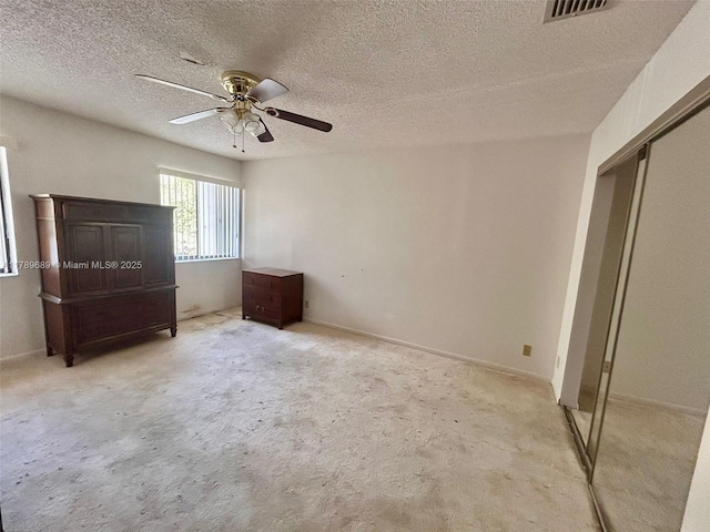 156 W Laurel Dr Unit 1006, Margate, FL 33063 - unfurnished bedroom with a ceiling fan, a closet, a textured ceiling, visible vents, and light colored carpet
