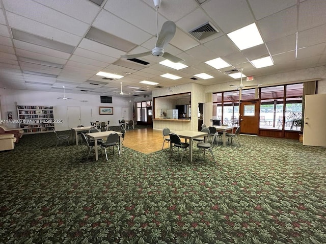 misc room featuring visible vents, carpet flooring, ceiling fan, and a drop ceiling