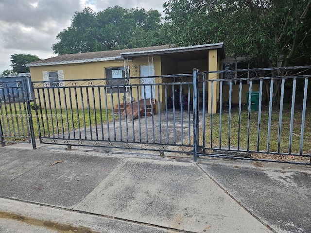 view of gate with a yard and a fenced front yard