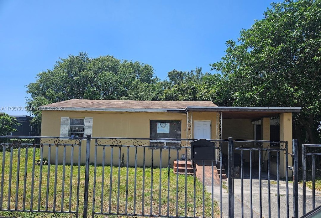 manufactured / mobile home with a fenced front yard, a gate, and a front yard