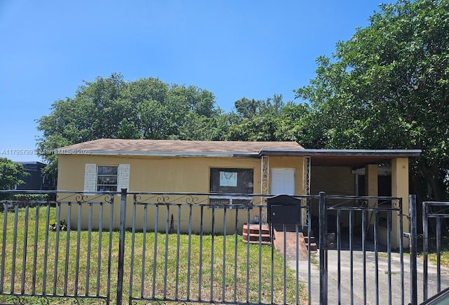manufactured / mobile home with a fenced front yard, a gate, and a front yard