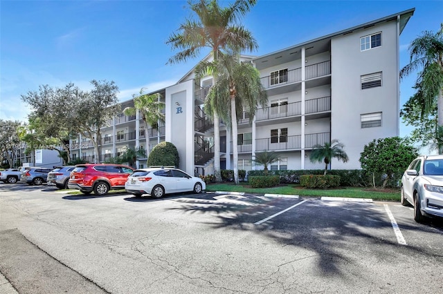 view of property featuring uncovered parking