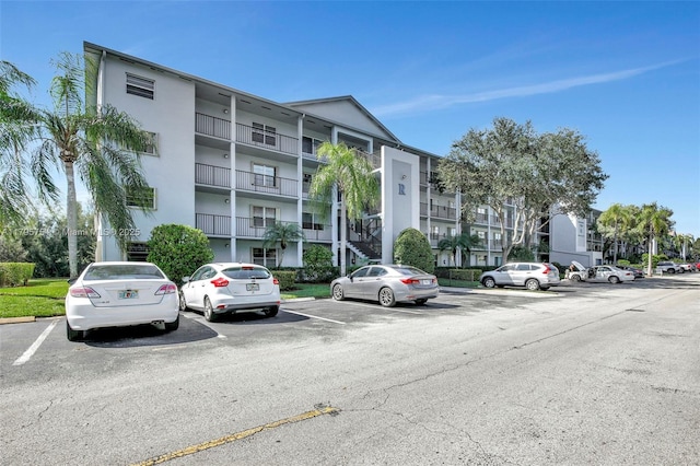 view of property featuring uncovered parking
