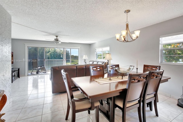 dining room featuring a textured ceiling, ceiling fan with notable chandelier, and light tile patterned floors