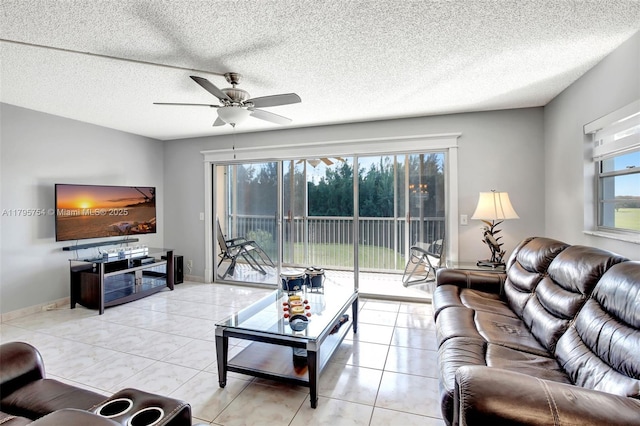 living room with a textured ceiling and ceiling fan