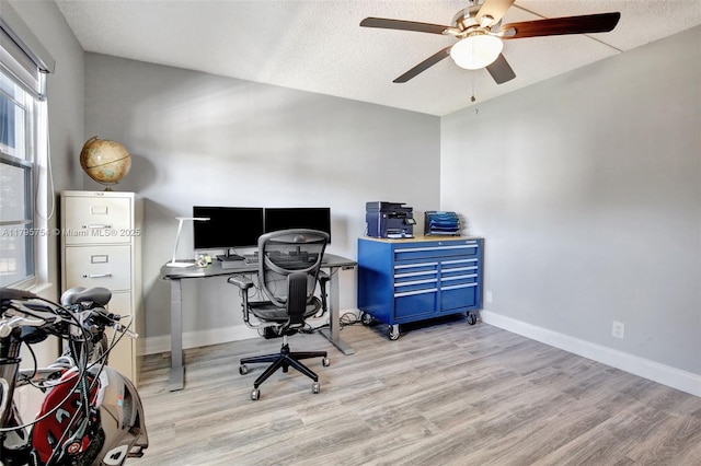office space with baseboards, a ceiling fan, and wood finished floors