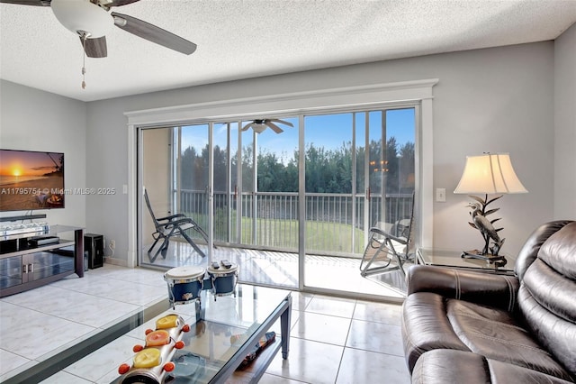 tiled living room featuring plenty of natural light, a ceiling fan, and a textured ceiling