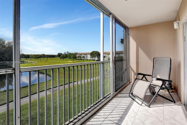 balcony with a water view and golf course view