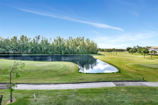 view of property's community with view of golf course, a water view, and a yard