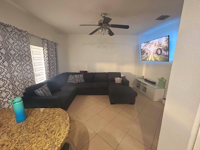 living room with light tile patterned floors, ceiling fan, and visible vents