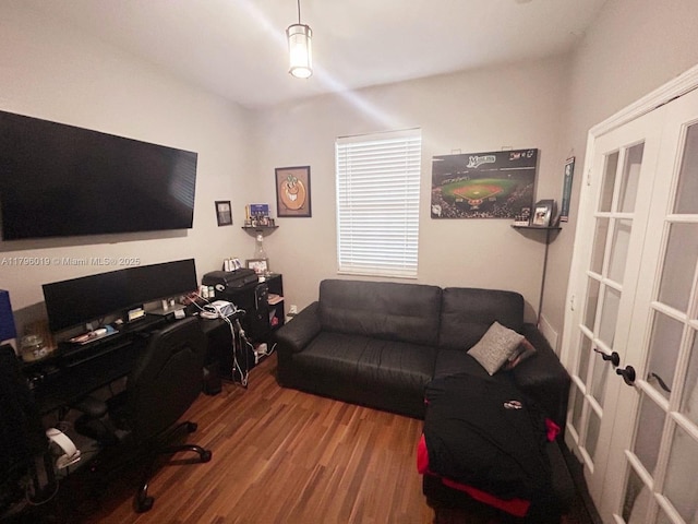 office with french doors and wood finished floors