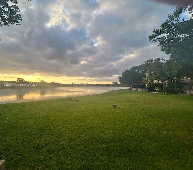 yard at dusk with a water view