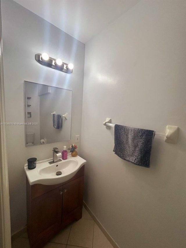 bathroom with vanity, baseboards, and tile patterned floors