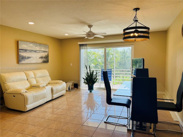 living room featuring light tile patterned flooring, baseboards, recessed lighting, a textured ceiling, and a ceiling fan