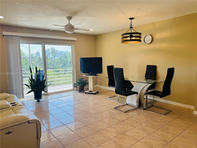 living room featuring light tile patterned flooring, baseboards, and ceiling fan