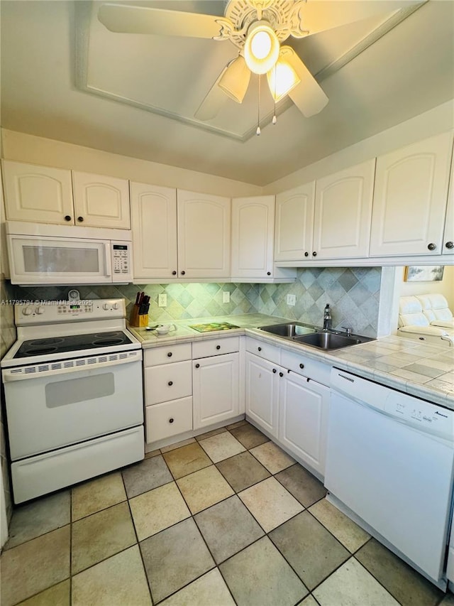 kitchen with white cabinets, ceiling fan, a sink, white appliances, and backsplash