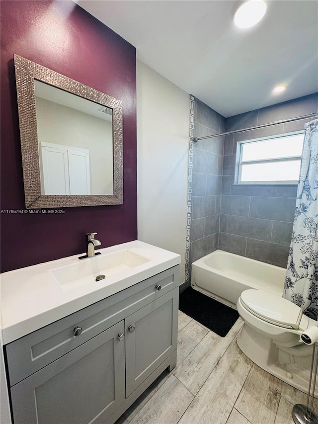 bathroom with vanity, shower / bath combo, toilet, and wood finished floors