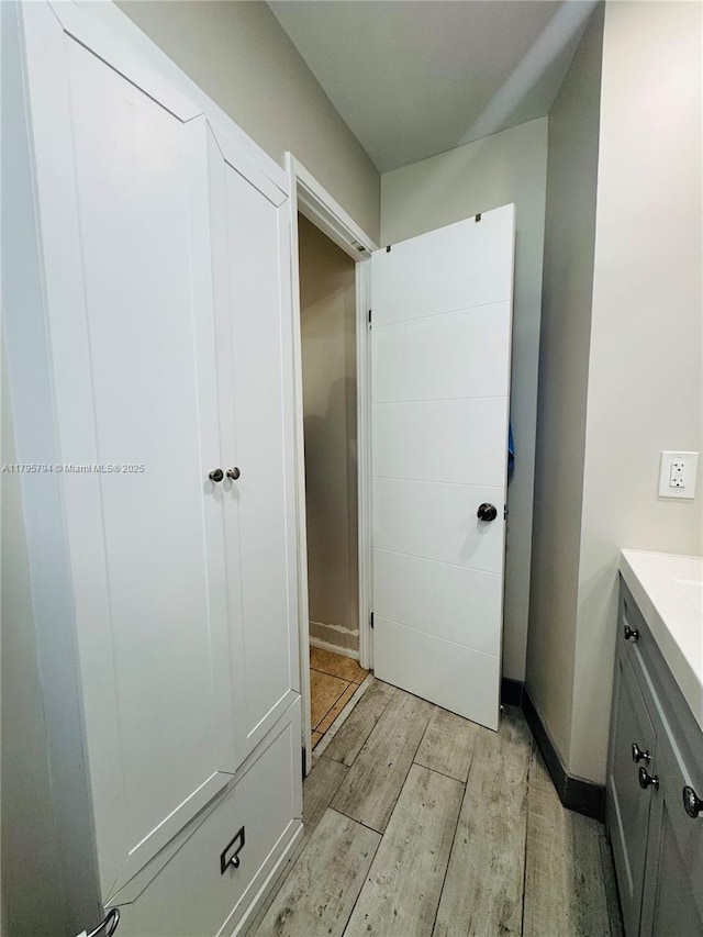 bathroom with wood finished floors and vanity