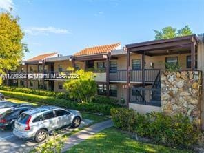 20841 San Simeon Way Unit 104, Miami, FL 33179 - view of property featuring uncovered parking
