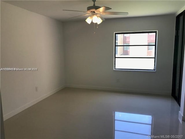 unfurnished room with baseboards and ceiling fan