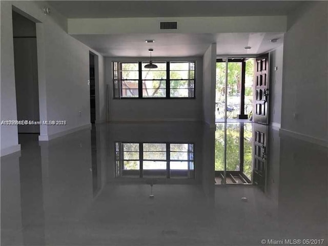 interior space featuring baseboards and visible vents
