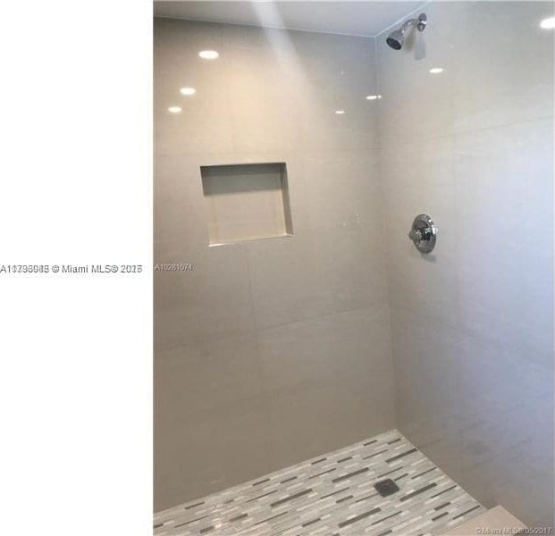 bathroom with a tile shower