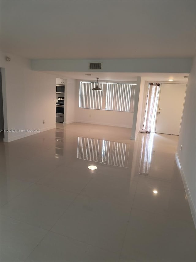 20841 San Simeon Way Unit 104, Miami, FL 33179 - spare room featuring tile patterned floors and baseboards