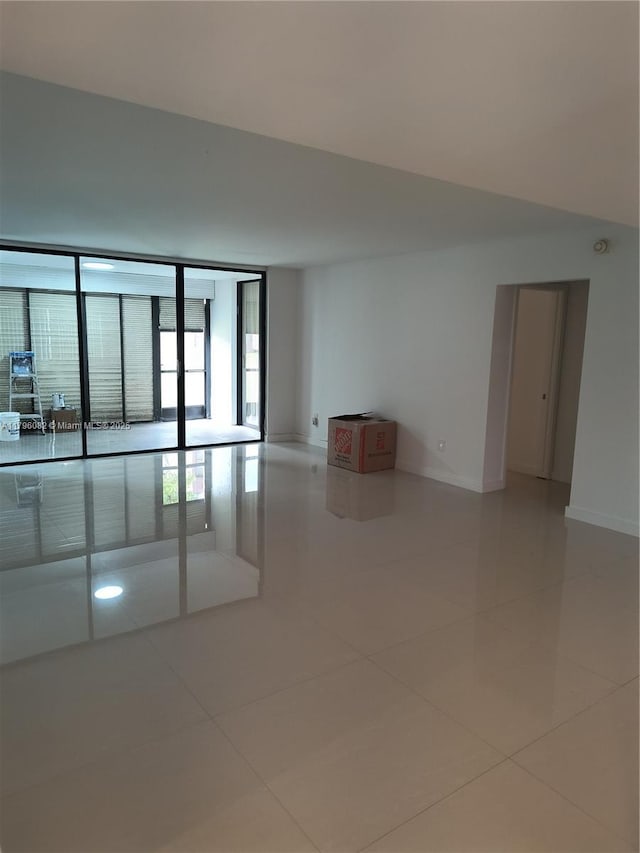 20841 San Simeon Way Unit 104, Miami, FL 33179 - empty room featuring tile patterned flooring and baseboards