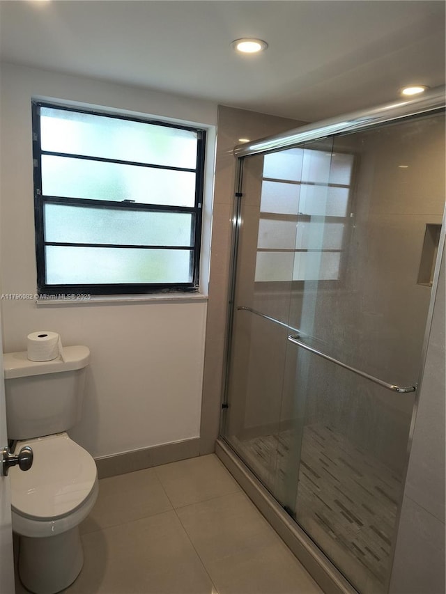 20841 San Simeon Way Unit 104, Miami, FL 33179 - bathroom with tile patterned floors, toilet, and a stall shower