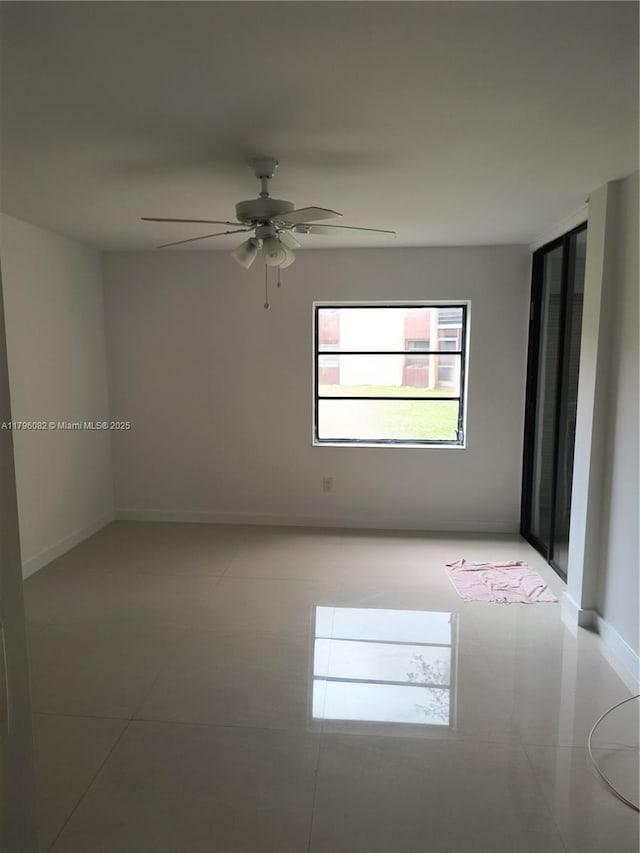 20841 San Simeon Way Unit 104, Miami, FL 33179 - empty room featuring ceiling fan, light tile patterned floors, and baseboards