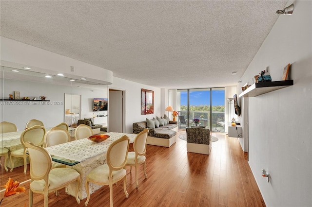 20505 E Country Club Dr Unit 732, Aventura, FL 33180 - dining space featuring a textured ceiling, light wood-style flooring, recessed lighting, and a wall of windows