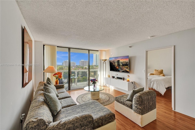 20505 E Country Club Dr Unit 732, Aventura, FL 33180 - living area featuring wood finished floors, expansive windows, and a textured ceiling