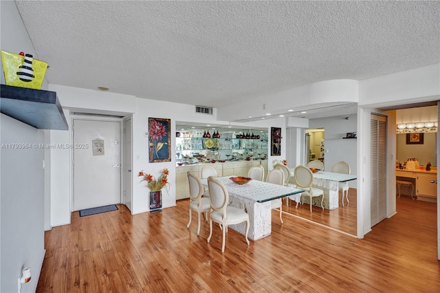 20505 E Country Club Dr Unit 732, Aventura, FL 33180 - dining area with a textured ceiling and light wood-style floors