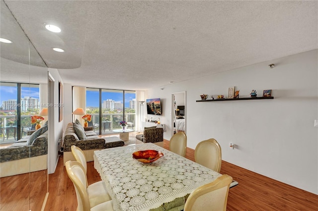20505 E Country Club Dr Unit 732, Aventura, FL 33180 - dining space with wood finished floors, a textured ceiling, a view of city, and recessed lighting