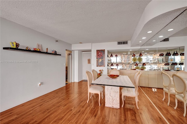 20505 E Country Club Dr Unit 732, Aventura, FL 33180 - dining space with wood finished floors, a textured ceiling, and recessed lighting