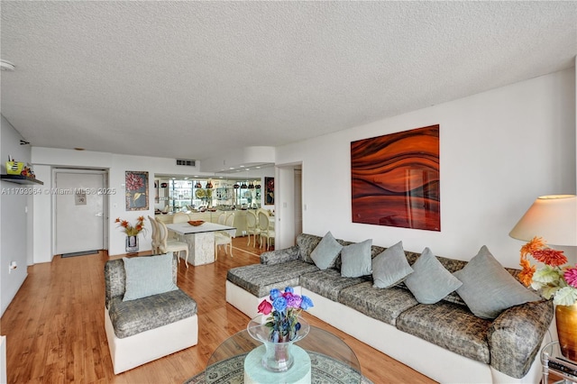 20505 E Country Club Dr Unit 732, Aventura, FL 33180 - living area with a textured ceiling and wood finished floors