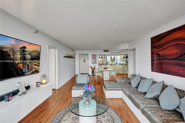 20505 E Country Club Dr Unit 732, Aventura, FL 33180 - living area with a textured ceiling and wood finished floors