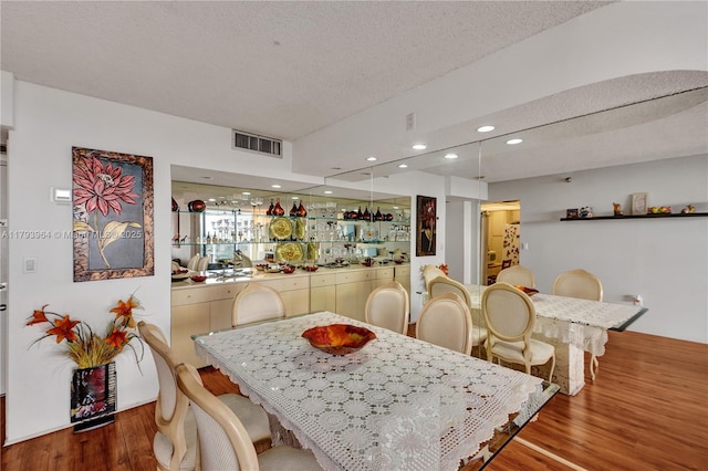 20505 E Country Club Dr Unit 732, Aventura, FL 33180 - dining room with wood finished floors, a textured ceiling, and recessed lighting