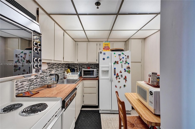 20505 E Country Club Dr Unit 732, Aventura, FL 33180 - kitchen with white appliances, a drop ceiling, a sink, tasteful backsplash, and white cabinets