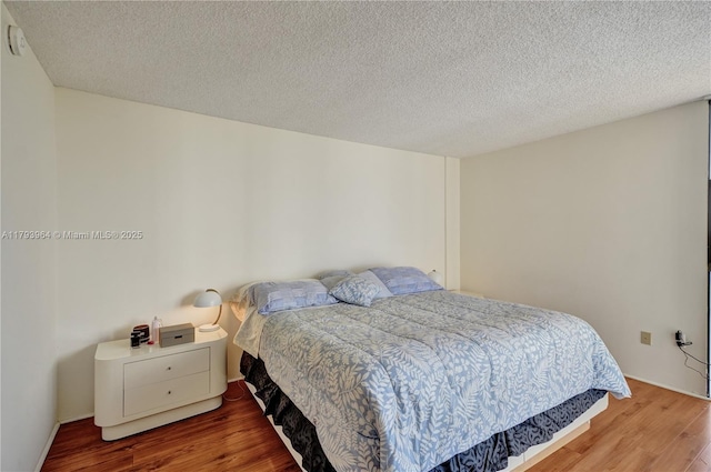 20505 E Country Club Dr Unit 732, Aventura, FL 33180 - bedroom featuring wood finished floors and a textured ceiling