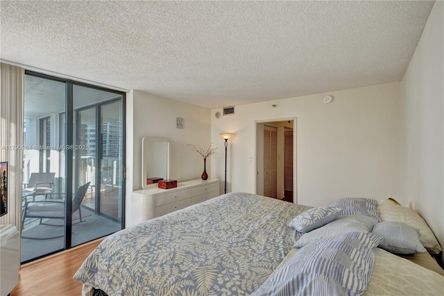 20505 E Country Club Dr Unit 732, Aventura, FL 33180 - bedroom with access to outside, wood finished floors, a textured ceiling, and a wall of windows