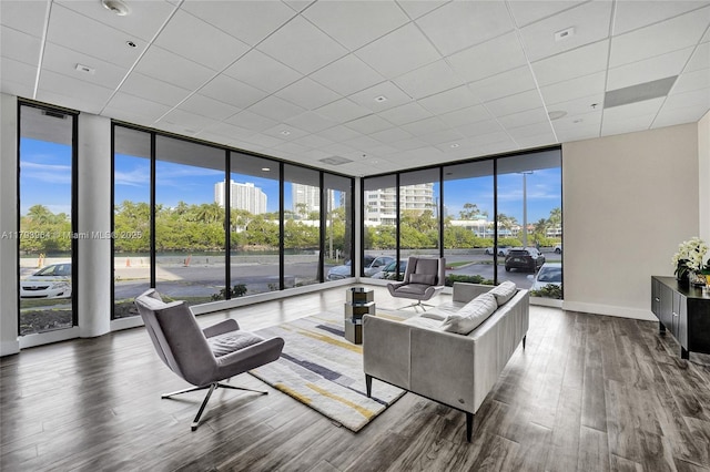 20505 E Country Club Dr Unit 732, Aventura, FL 33180 - living room with a wall of windows, wood finished floors, a drop ceiling, plenty of natural light, and baseboards