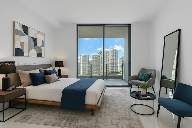 bedroom with a city view, access to exterior, and a wall of windows