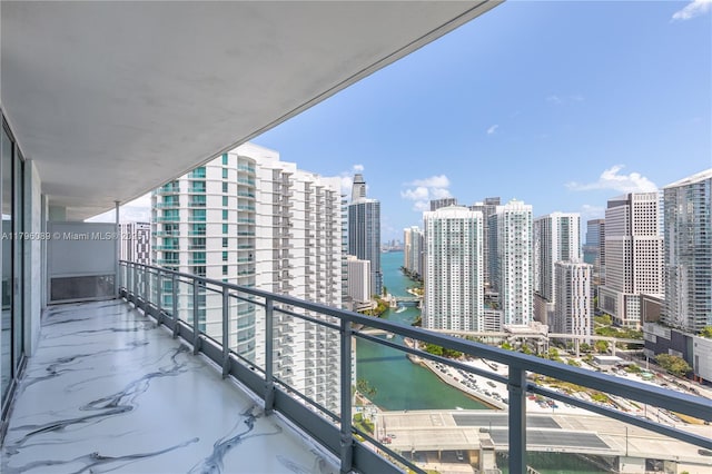 balcony featuring a city view and a water view