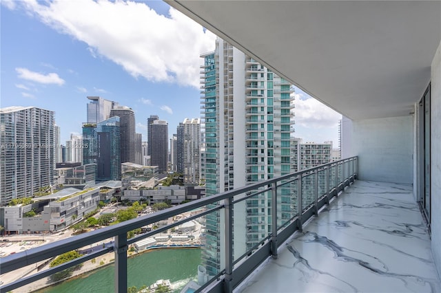 balcony with a water view and a city view